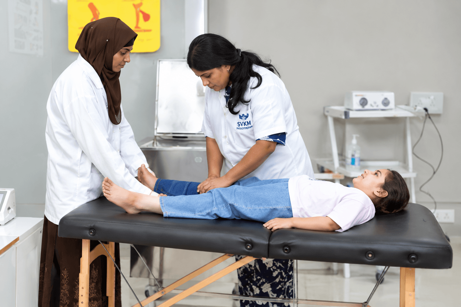Therapists working with a child on a treatment table