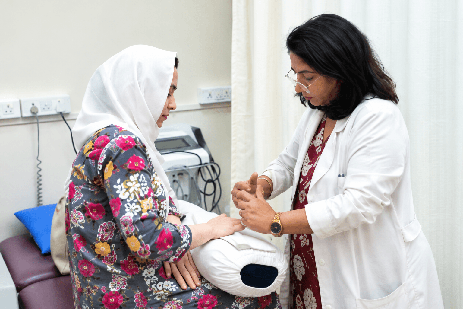 A physiotherapist guiding a patient through a hand exercise